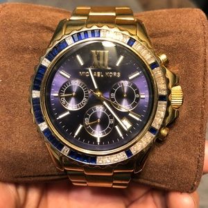 Gold Woman’s Michael Kors watch.